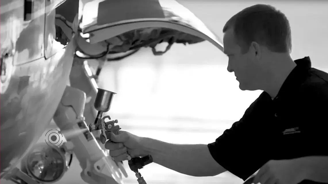 Person working on a vehicle with a white background